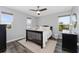This bedroom features windows, hardwood floors, a ceiling fan, and a black wood bed frame at 14421 Ward Rd, Orlando, FL 32824
