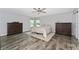 Main bedroom suite with wood floors, two dressers, and a comfortable bed at 14421 Ward Rd, Orlando, FL 32824