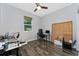 Bedroom featuring a ceiling fan, a desk, a comfortable office chair, and a large window at 14421 Ward Rd, Orlando, FL 32824