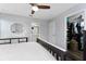 This bedroom features a view of the bathroom, a walk-in closet, hardwood floors, and a ceiling fan at 14421 Ward Rd, Orlando, FL 32824