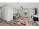 Bonus room with comfortable sofa, ceiling fan, large window at 14421 Ward Rd, Orlando, FL 32824