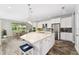 Open kitchen with an island, pendant lighting, seating, stainless steel appliances, and a dining area at 14421 Ward Rd, Orlando, FL 32824