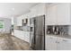 Spacious kitchen features stainless steel appliances, white cabinets, and a mosaic tile backsplash at 14421 Ward Rd, Orlando, FL 32824