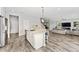 Bright kitchen with open layout shows the island, stairs to the second floor, and living area at 14421 Ward Rd, Orlando, FL 32824