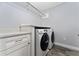 This laundry room features Samsung washers and dryers, and white cabinets at 14421 Ward Rd, Orlando, FL 32824