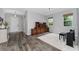 Bright living room showcasing wood floors, natural light, and a piano creates a welcoming ambiance at 14421 Ward Rd, Orlando, FL 32824