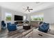 Cozy living room complete with neutral paint, wood flooring, a ceiling fan, and large windows at 14421 Ward Rd, Orlando, FL 32824