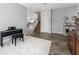 Comfortable living room featuring a staircase, wood floors, and a piano adding to its charm at 14421 Ward Rd, Orlando, FL 32824
