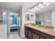 The bathroom includes double sinks with granite countertops and an open view of the adjacent bedroom at 1456 Belle Terre Rd, Davenport, FL 33896