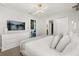 This bedroom features modern decor, a queen bed, and a TV on the wall above a white dresser at 1456 Belle Terre Rd, Davenport, FL 33896