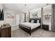 This stylish bedroom is well lit, featuring modern decor, a comfortable bed, and a serene ambiance at 1456 Belle Terre Rd, Davenport, FL 33896