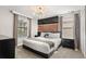 The bedroom is modern and stylish, featuring a unique headboard design and ample natural light at 1456 Belle Terre Rd, Davenport, FL 33896