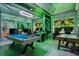 Themed game room features multiple gaming stations with neon accents at 1456 Belle Terre Rd, Davenport, FL 33896