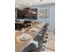 An elegant kitchen features dark cabinets and granite countertops, complemented by stylish bar stool seating at 1456 Belle Terre Rd, Davenport, FL 33896