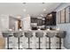 Kitchen bar featuring dark wood cabinetry, stainless steel appliances, and seating for five at 1456 Belle Terre Rd, Davenport, FL 33896