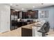 This kitchen showcases stainless steel appliances, dark wood cabinets, and a breakfast bar with seating at 1456 Belle Terre Rd, Davenport, FL 33896