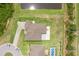 Overhead aerial view of the property showing the layout with pond, pool, and outdoor living spaces at 1504 Cordgrass Way, Lakeland, FL 33813