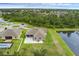 Stunning aerial view of the property with a pond, pool, and lush greenery in a serene neighborhood at 1504 Cordgrass Way, Lakeland, FL 33813