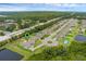 Aerial view of the property showcasing its location in a quiet neighborhood with pond and green space at 1504 Cordgrass Way, Lakeland, FL 33813