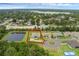 Aerial view of the property with lush landscaping and a nearby pond at 1504 Cordgrass Way, Lakeland, FL 33813