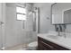 Modern bathroom features a glass-enclosed shower, white marble tile, and vanity with mosaic tile accents at 1504 Cordgrass Way, Lakeland, FL 33813
