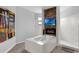 Elegant bathroom featuring a soaking tub with fireplace, a walk-in shower, and modern fixtures at 1504 Cordgrass Way, Lakeland, FL 33813