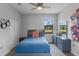 Cozy bedroom with ceiling fan, dresser, and serene outdoor views from the window at 1504 Cordgrass Way, Lakeland, FL 33813