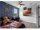Bedroom with ceiling fan, wood floors, and wall decor at 1504 Cordgrass Way, Lakeland, FL 33813
