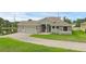 Charming single-story home featuring a three-car garage, well-maintained lawn, and elegant stone accents at 1504 Cordgrass Way, Lakeland, FL 33813