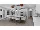 Bright, modern kitchen with a large central island featuring seating, stainless steel appliances, and stylish pendant lighting at 1504 Cordgrass Way, Lakeland, FL 33813
