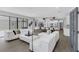 Spacious living room with white furniture, wood floors, and a view to the kitchen at 1504 Cordgrass Way, Lakeland, FL 33813