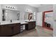 Spacious bathroom featuring a double sink vanity with wood cabinets and a large mirror at 1504 Cordgrass Way, Lakeland, FL 33813