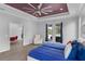 Bedroom with wood floors, easy chair, and doors to the outside at 1504 Cordgrass Way, Lakeland, FL 33813