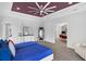 Comfortable bedroom featuring wood floors, white furniture, and views into an adjacent room at 1504 Cordgrass Way, Lakeland, FL 33813