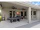 Inviting covered outdoor patio with fans, TV, grill, and space for relaxation and entertainment at 1504 Cordgrass Way, Lakeland, FL 33813