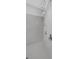 Luxurious walk-in shower with multiple shower heads and sleek, modern tile work at 1504 Cordgrass Way, Lakeland, FL 33813