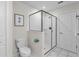 Modern bathroom featuring a glass-enclosed shower with a tiled interior and marble flooring at 1560 Maidstone Ct, Davenport, FL 33896