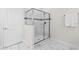 Bathroom with glass shower, white tile, and marble look tile at 1560 Maidstone Ct, Davenport, FL 33896