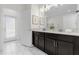 Bathroom with double vanity, quartz countertops, and marble-look floors at 1560 Maidstone Ct, Davenport, FL 33896