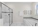 Bright bathroom with walk-in shower, soaking tub, and marble look tile at 1560 Maidstone Ct, Davenport, FL 33896