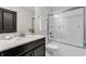 Clean bathroom features a single vanity and a shower-tub combination with glass doors at 1560 Maidstone Ct, Davenport, FL 33896