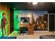 A bedroom with a desk, a TV, cartoon-themed murals, and green lighting at 1560 Maidstone Ct, Davenport, FL 33896