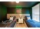 The bedroom features two beds with decorative pillows and a cartoon-themed background at 1560 Maidstone Ct, Davenport, FL 33896