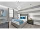Modern bedroom with gray, white, and blue decor, with a large decorative headboard at 1560 Maidstone Ct, Davenport, FL 33896