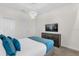 Stylish bedroom boasts a TV, modern lighting, and a comfortable bed at 1560 Maidstone Ct, Davenport, FL 33896