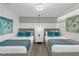 Well-decorated bedroom featuring two beds, stylish decor, and modern lighting at 1560 Maidstone Ct, Davenport, FL 33896