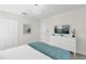 Well-lit bedroom with a modern dresser, wall-mounted TV, and minimalist decor at 1560 Maidstone Ct, Davenport, FL 33896