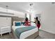 Guest bedroom with accent wall, neutral decor, modern lighting, and ensuite bath at 1560 Maidstone Ct, Davenport, FL 33896