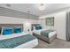 Comfortable bedroom with two beds, blue pillows, and decorative wall accents at 1560 Maidstone Ct, Davenport, FL 33896