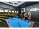 The custom designed game room includes a pool table and Star Wars themed pinball machine at 1560 Maidstone Ct, Davenport, FL 33896